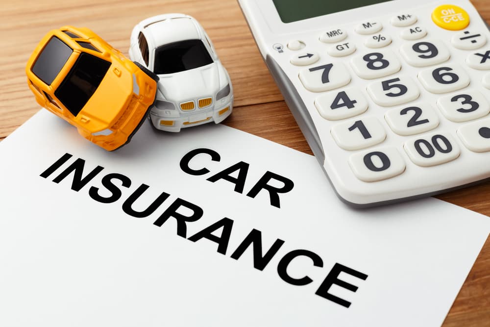 Creating a visual concept of car insurance with a calculator on a wooden table can be an engaging and relatable way to depict financial planning and decision-making.