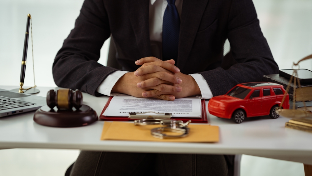 Insurance for court claims in the courtroom. Gavels and small toy car models, with two cars on the table in the court. Lawyer service concept trial. Close-up images.